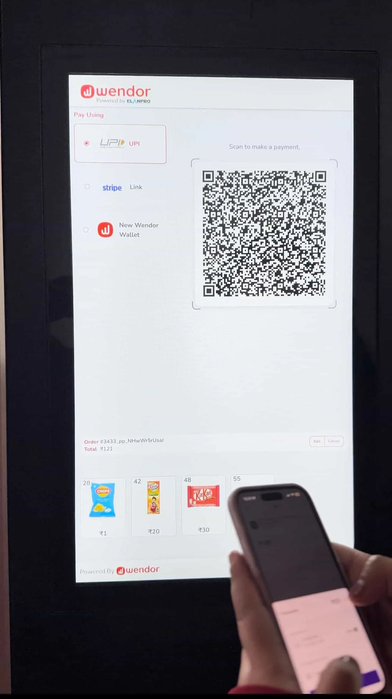 Shopper scanning a UPI QR code on the Nova Elevator screen