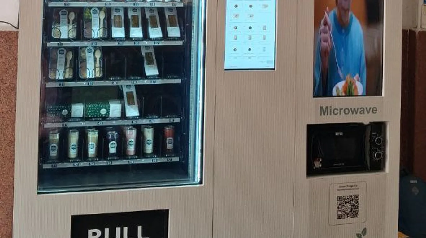 Connected smart vending machines across a modern Indian tech campus at golden hour