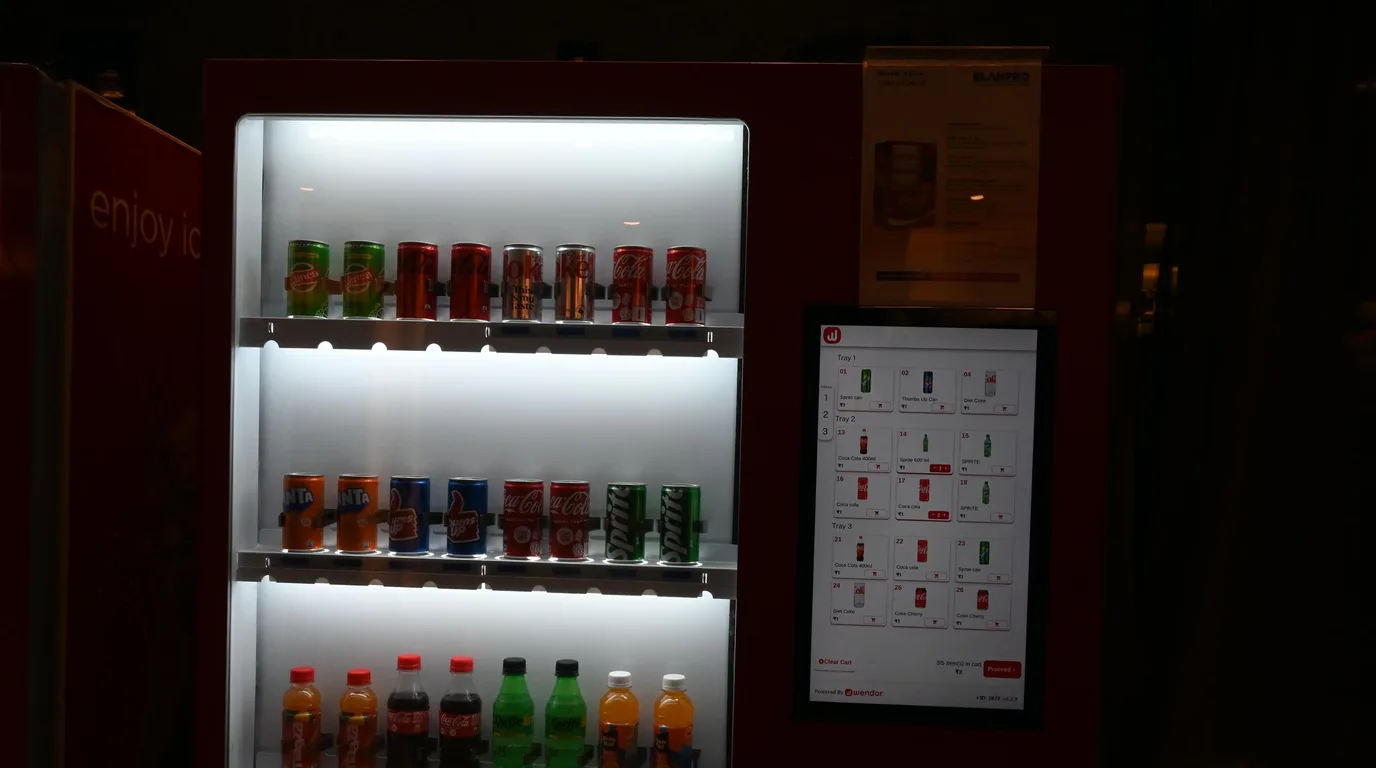 Four-step sequence of paying, selecting, dispensing, and stock update at a vending machine