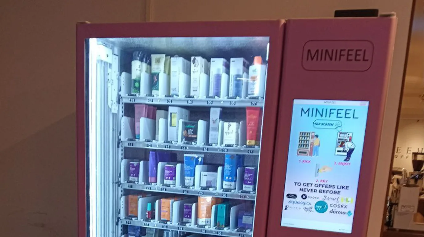 Entrepreneur stocking and managing their first smart snack vending machine